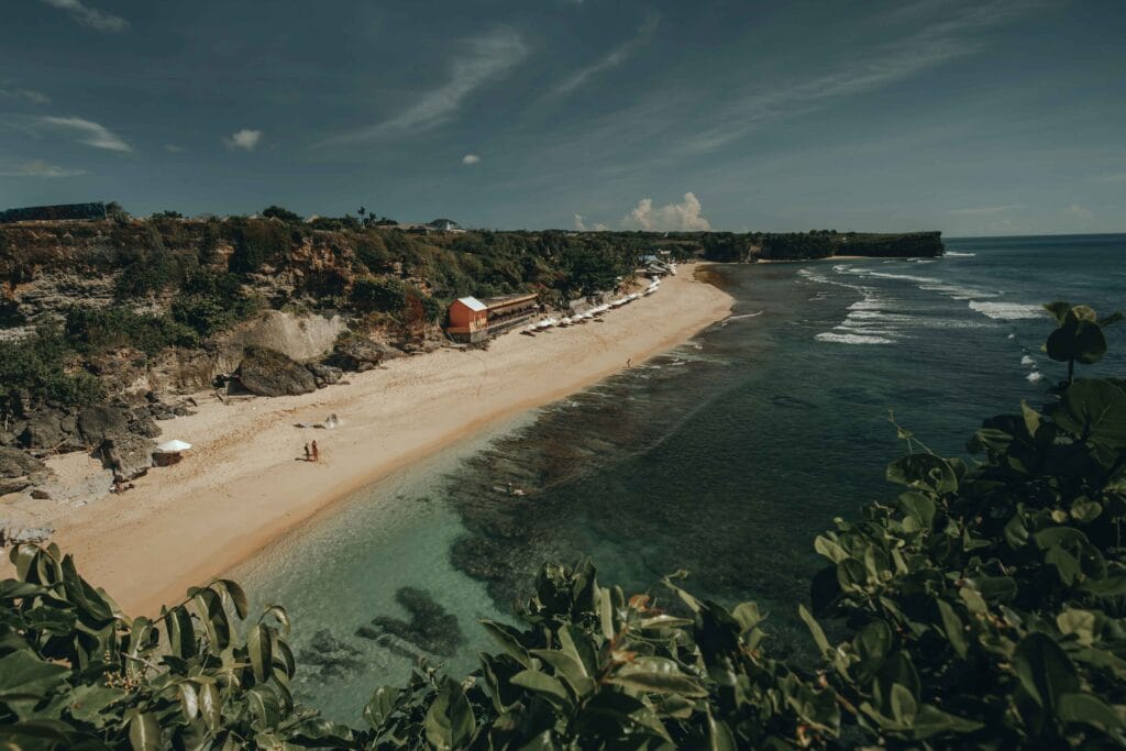 Amazing aerial Bali beach coast at ocean waves crashing to sand. Tropical paradise Indonesia island