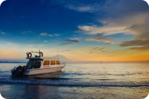 Tranquil boat anchored off the coast at sunset in Sanur, Bali—Best Spots in Sanur by Coco Development Group.