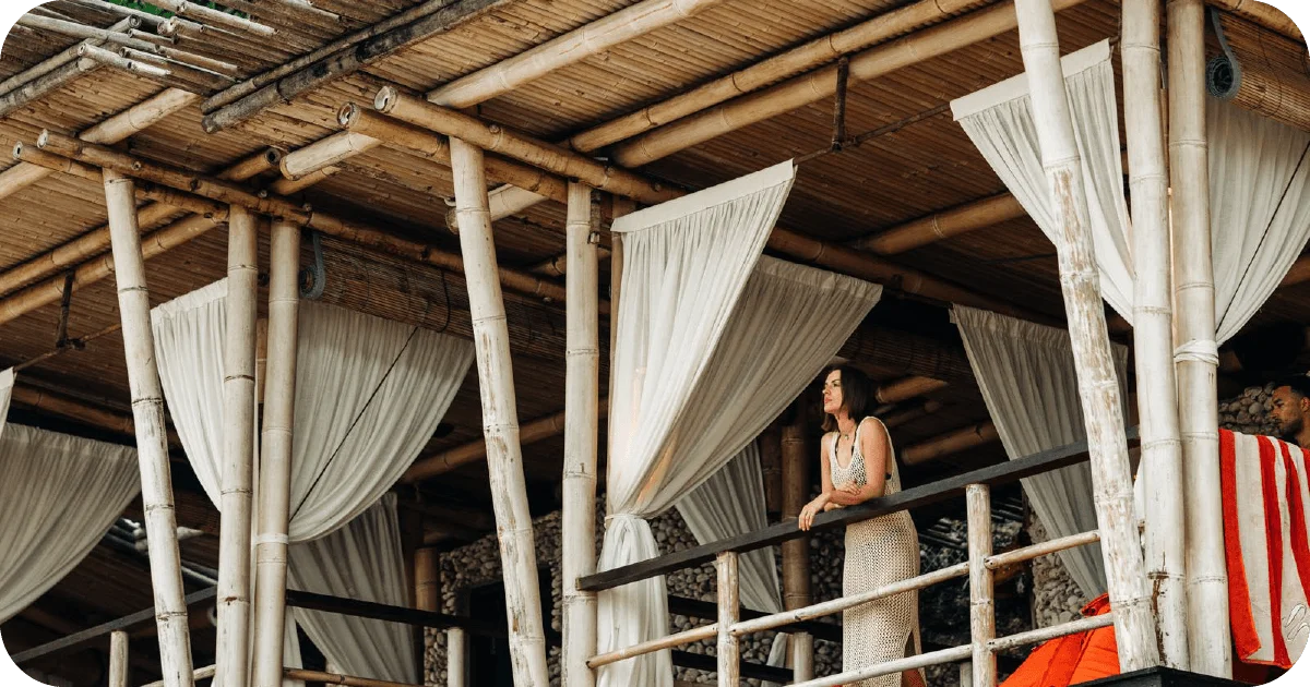 Bamboo cabana terrace with billowing white curtains and railings