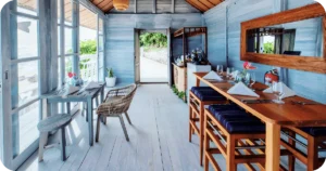 Bright coastal bar interior with wooden high-top tables and place settings