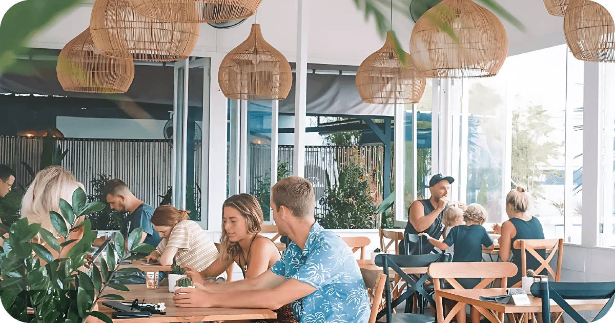 Bright dining room with rattan pendants and wooden tables