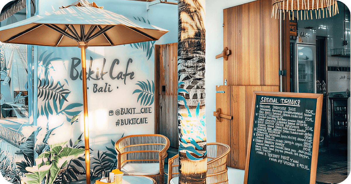 Bukit Cafe Bali mural exterior with seating and specials board