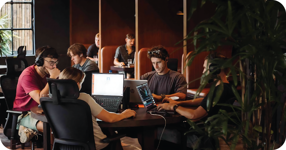 Coworking area with laptops and booth seating behind