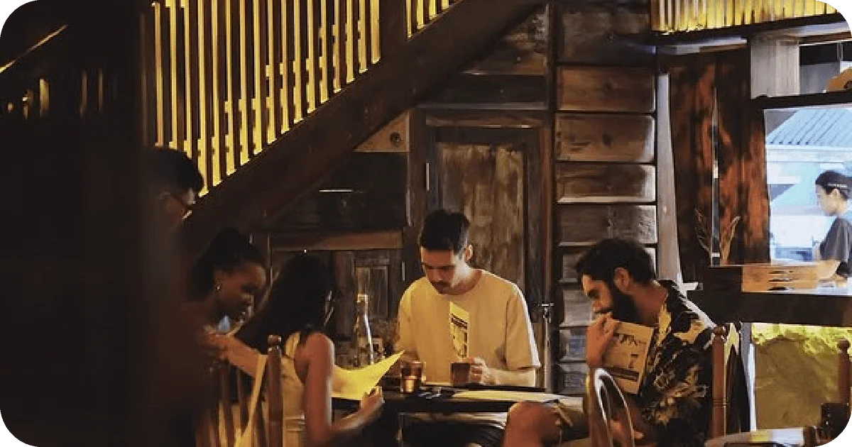 Cozy wooden nook with diners reading menus