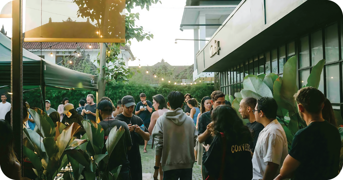 Evening crowd outside Monday with string lights and garden