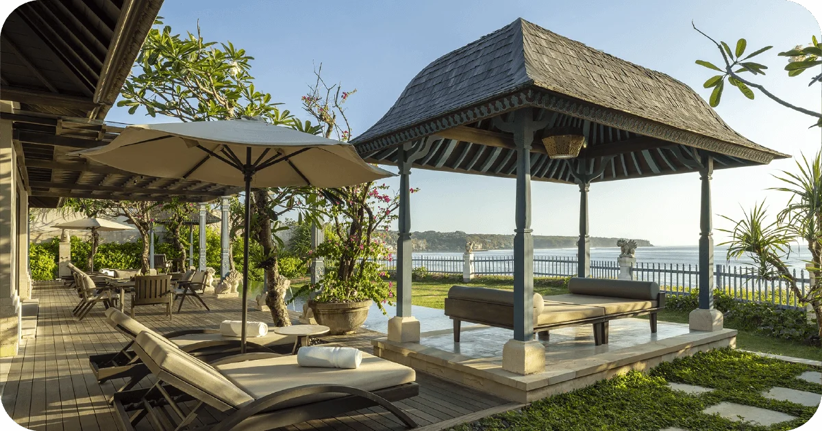 Garden terrace with pavilion, loungers, and ocean view