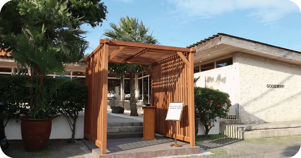 Gooseberry entrance with wooden pergola host stand and stone facade