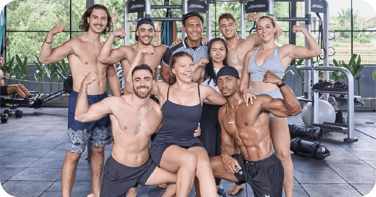 Large group posing and flexing in open gym area