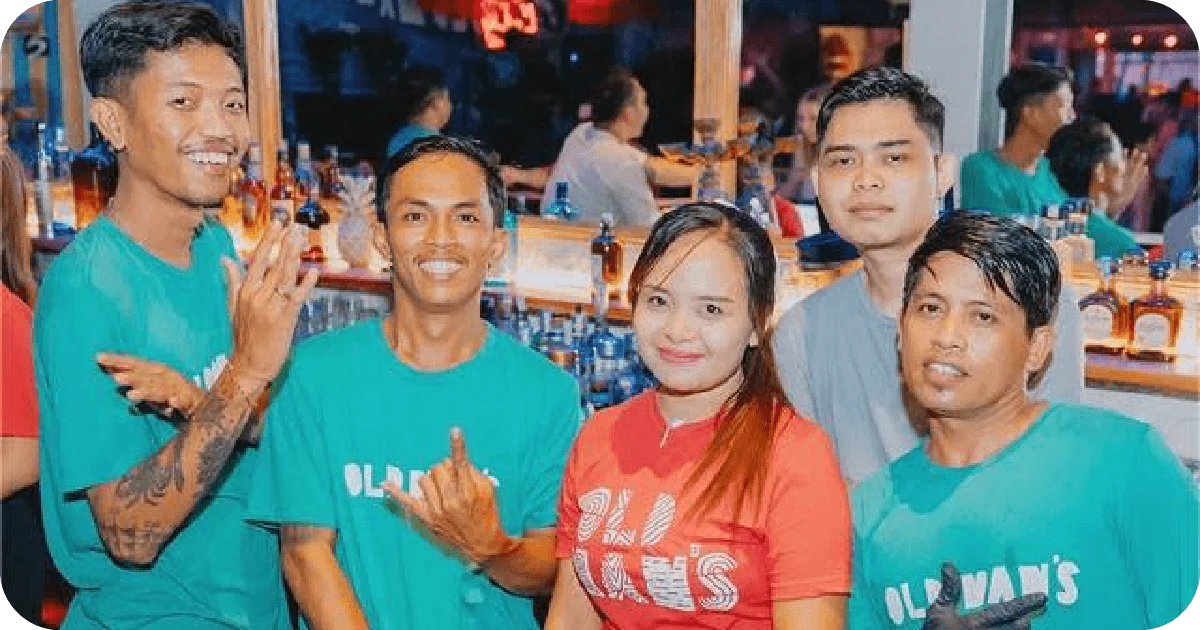 Staff posing in colorful t-shirts.