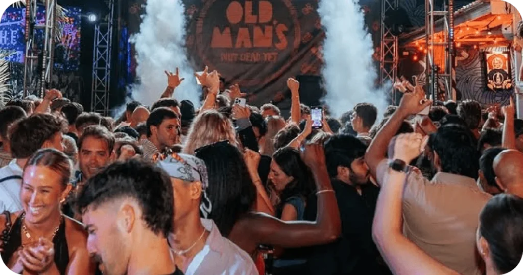 Old Man's stage with smoke effects and dense dancing crowd