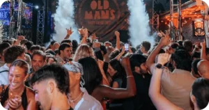 Old Man's stage with smoke effects and dense dancing crowd