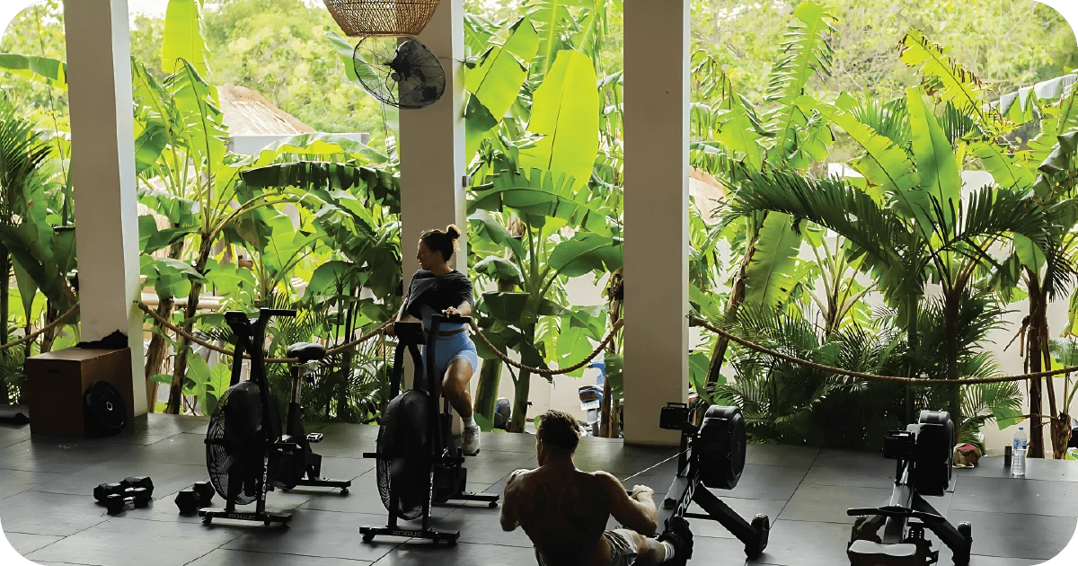 Open-air cardio area with air bikes and rowing machines