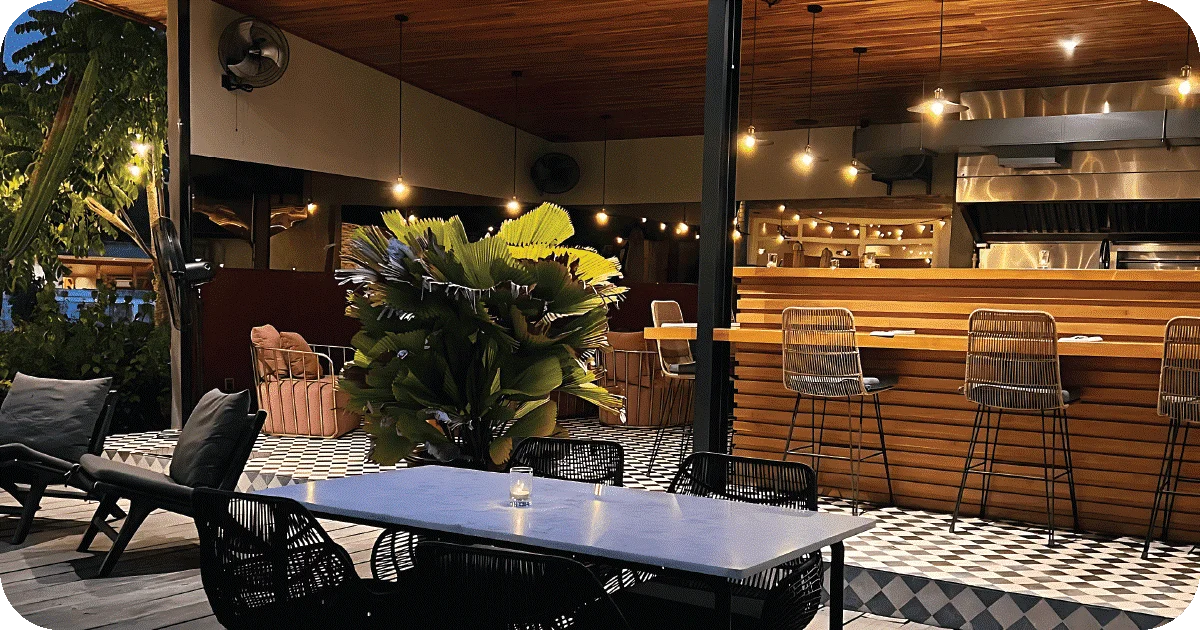 Open-air dining room with bar seating and open kitchen