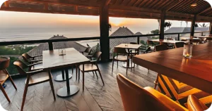 Open-air dining room with ocean views and wooden tables