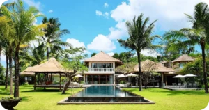 Palm-lined lawn facing villa with long central reflecting pool