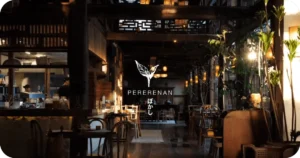 Pererenan logo inside rustic, plant-filled dining space