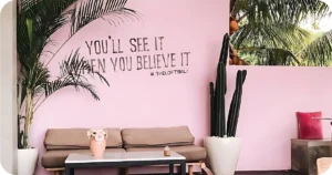 Pink lounge wall with quote and #TheLoftBali branding