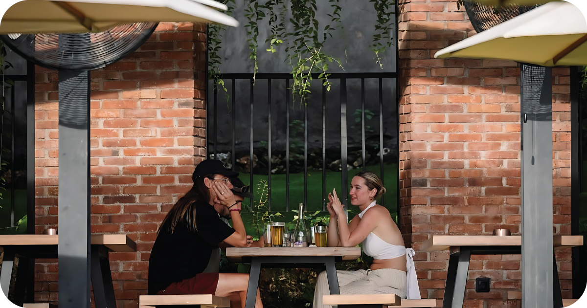 Shaded brick patio with picnic tables, pints and water carafe