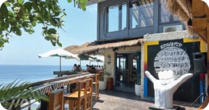 Single Fin entrance deck with ocean-view bar stools and mural