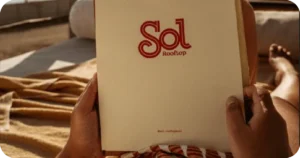Sol Rooftop branded menu held on sun lounger