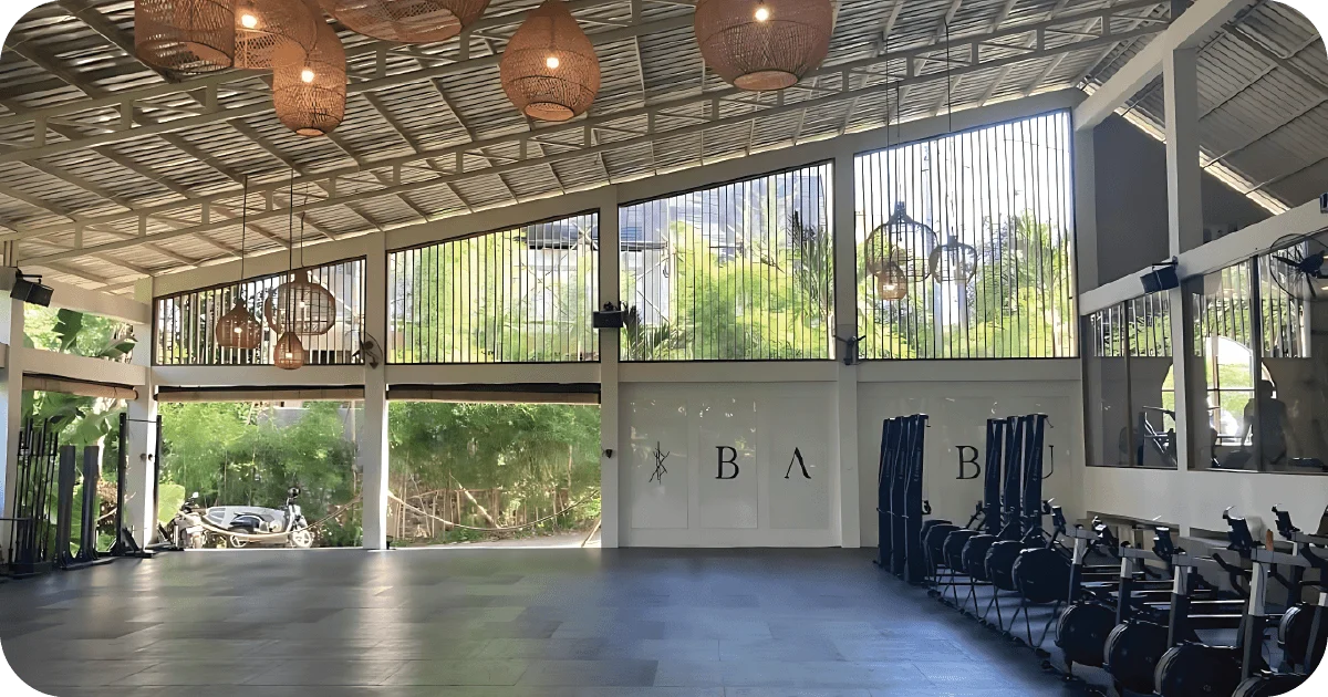 Spacious Bambu Fitness studio with open floor and rowers stacked