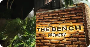 THE BENCH BREWERY illuminated brick sign by tropical plants