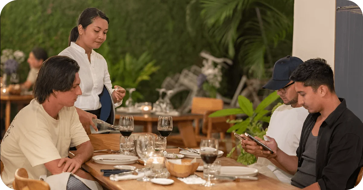 Table service with wine in garden-side dining area