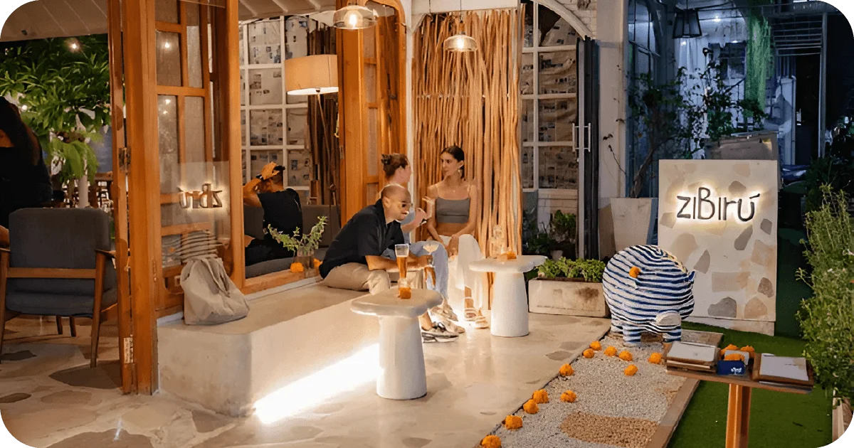 ziBirú front patio seating with low tables and warm lighting