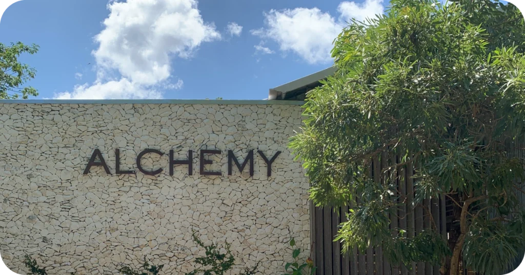 Alchemy stone wall exterior with large metal letter signage