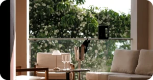 Balcony nook with champagne bucket, wine glasses, and cushioned seating