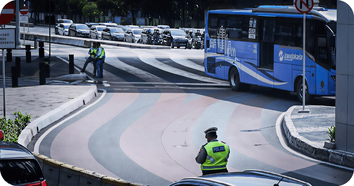 Blue city bus turning as traffic police direct vehicles