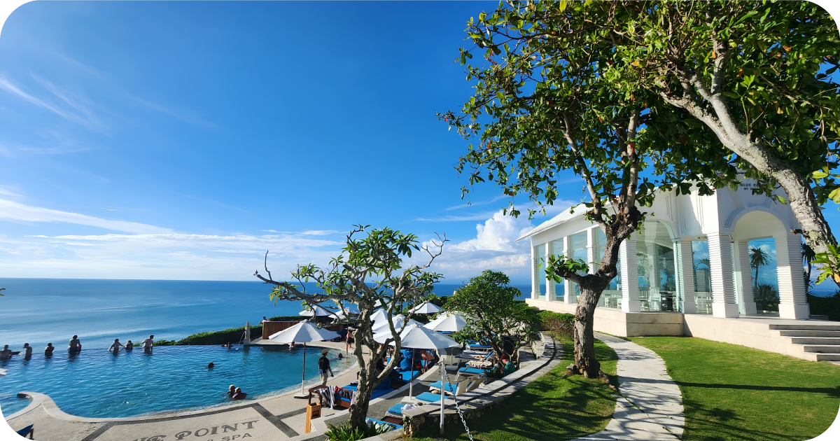 Cliffside infinity pool with ocean panorama and white chapel