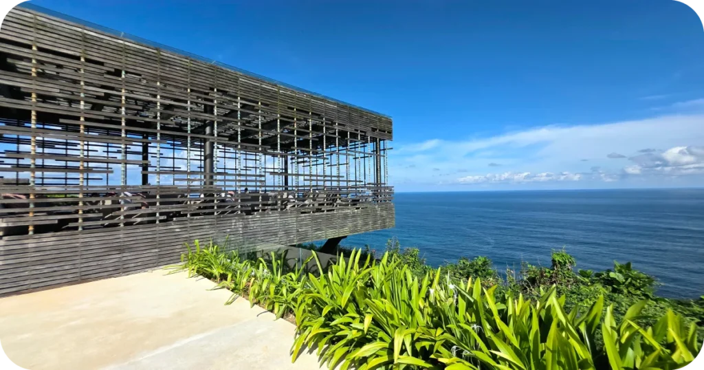The Warung at Alila Uluwatu: Cliffside open-air pavilion with wooden slats overlooking the ocean