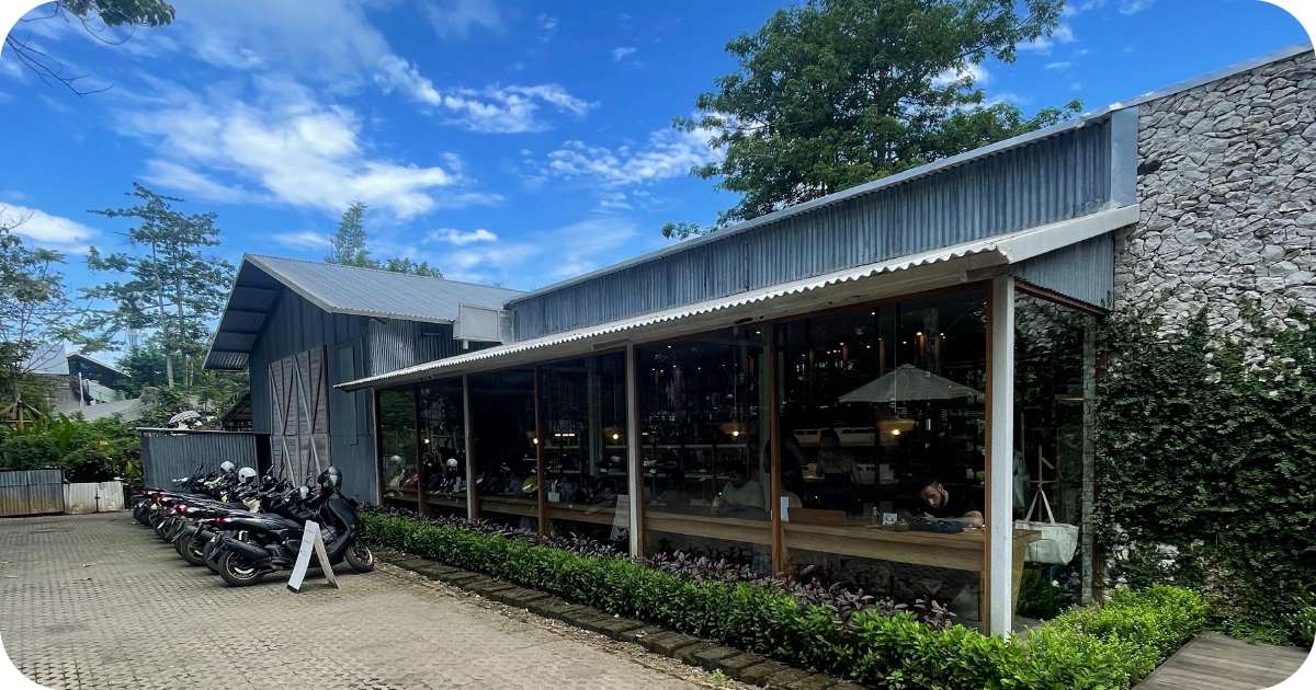 Corrugated metal exterior with glass windows and scooter parking