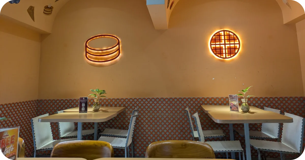 Cozy booth seating with pancake and waffle neon wall lights