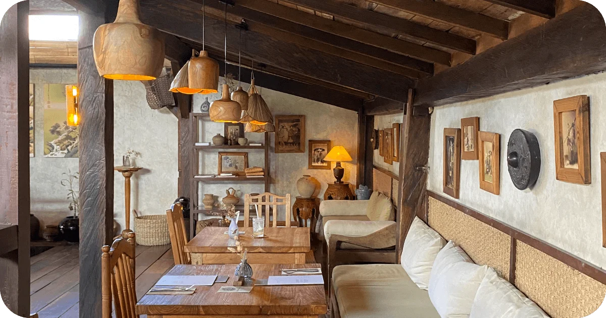 Cozy dining room with wooden beams, pendant lights, framed art