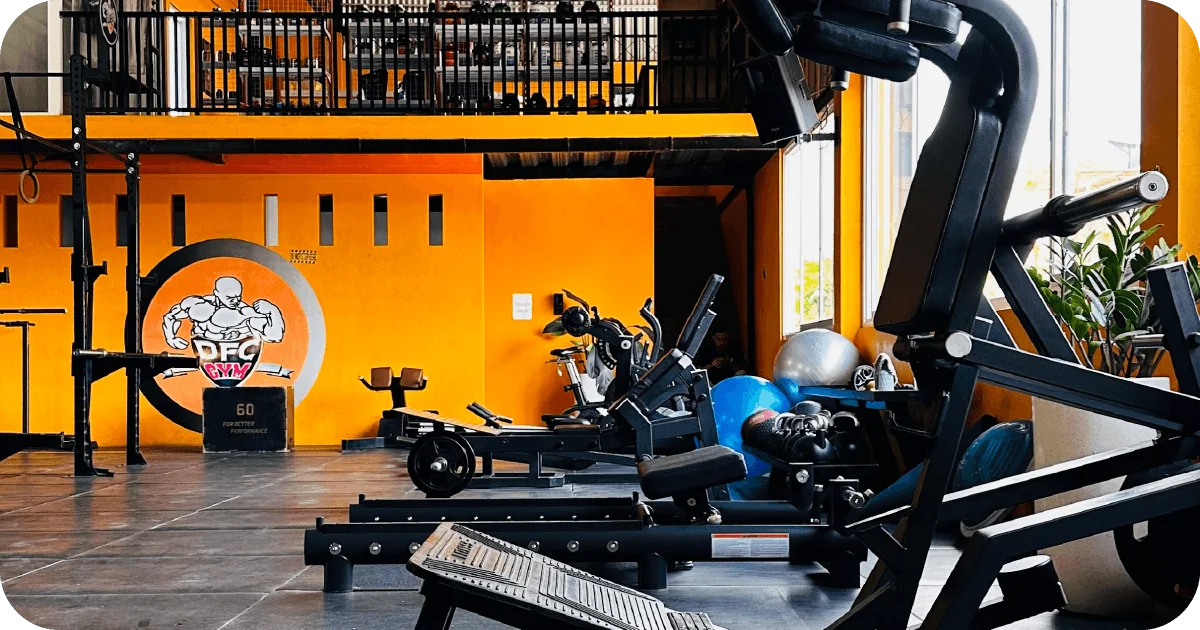 DFC Gym strength area with leg press, benches and stability balls