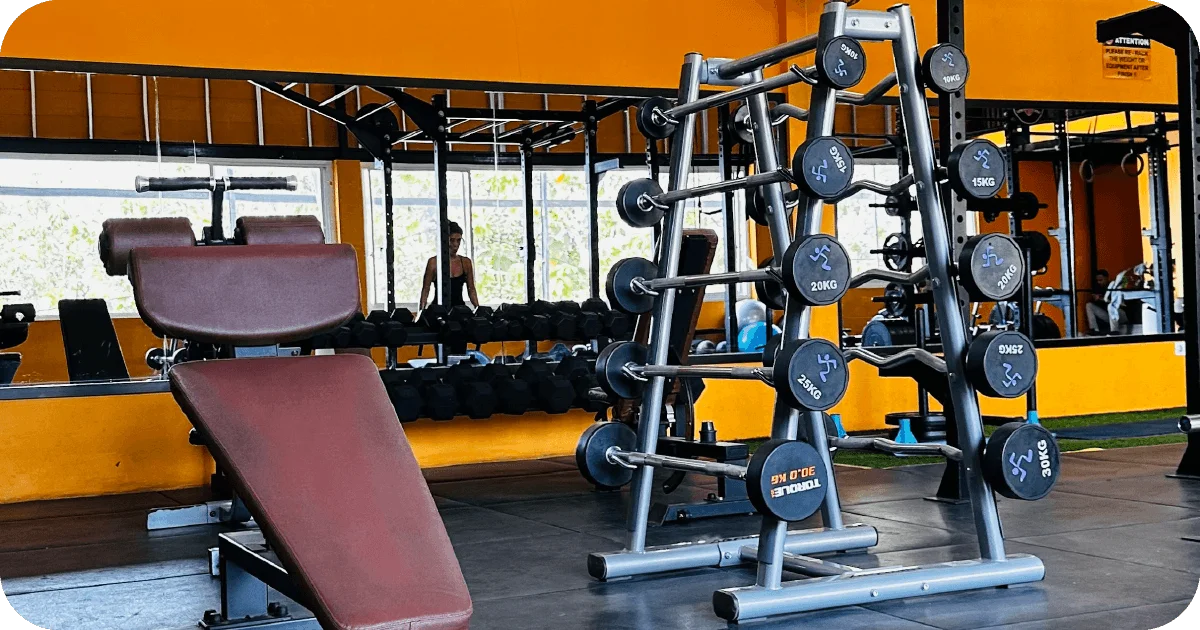 Dumbbell racks and adjustable bench in mirrored free weights area