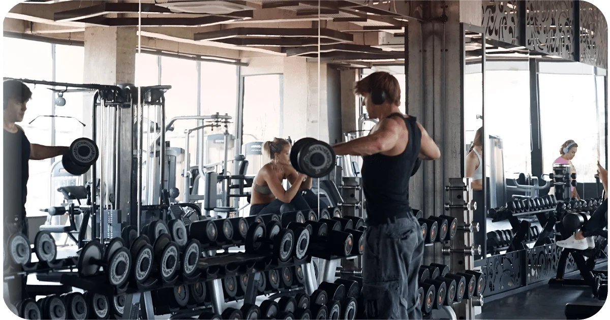 Surya Gym Bali: The Ultimate Review of Canggu's Premier Fitness Destination 2 Dumbbell racks with mirrors and members doing free-weight training