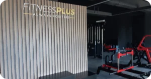 Fitness Plus Gym Uluwatu: lobby sign beside selectorized machines