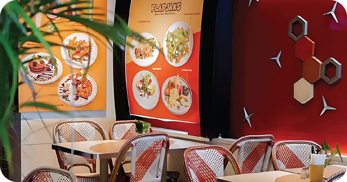 Flapjaks Bali dining area with rattan chairs, menu posters, geometric wall decor