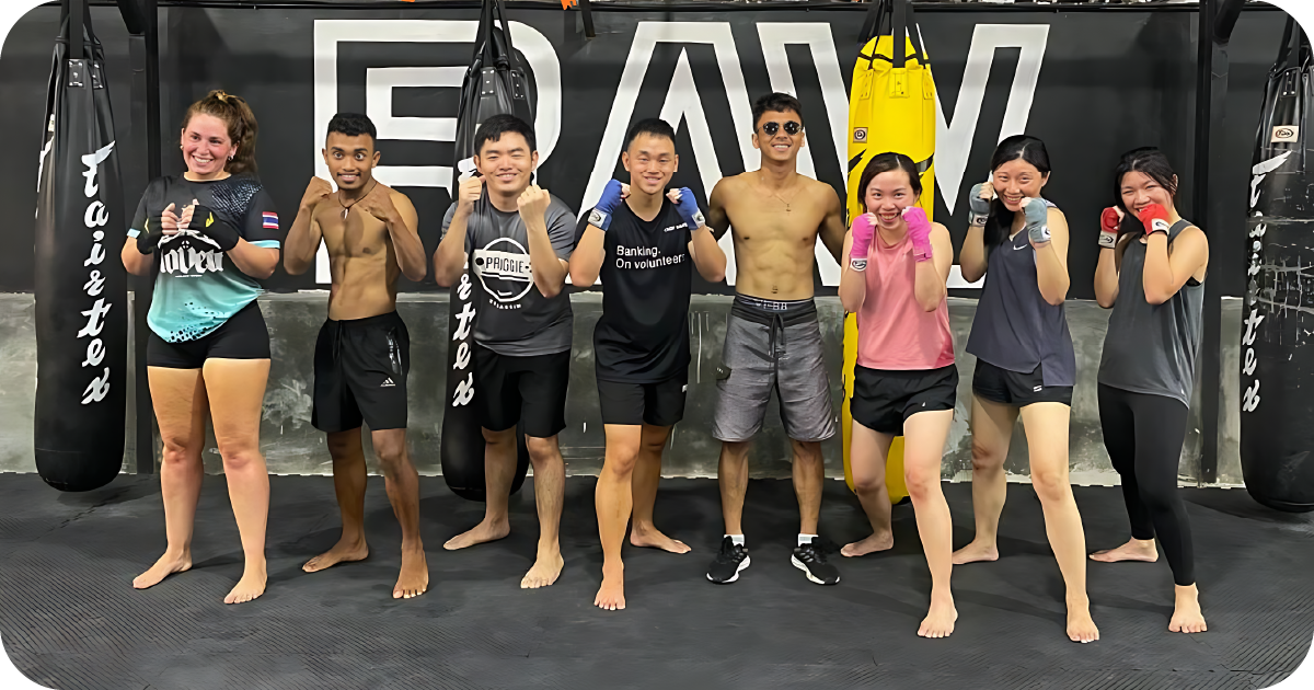 Group boxing class posing by Fairtex bags at RAW