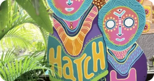 Hatch colorful mural sign amid lush tropical plants