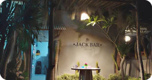 JACK BAR Bali exterior wall signage amid tropical plants and a standing table