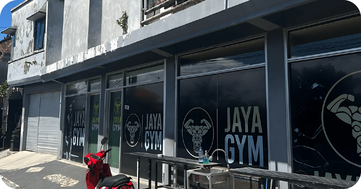 Jaya Gym exterior with large window decals, outdoor bench and sink