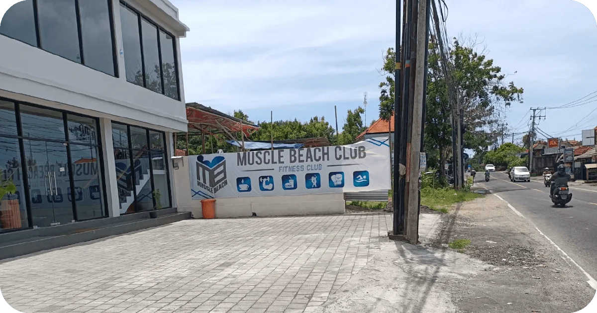 Muscle Beach Club exterior with large roadside banner