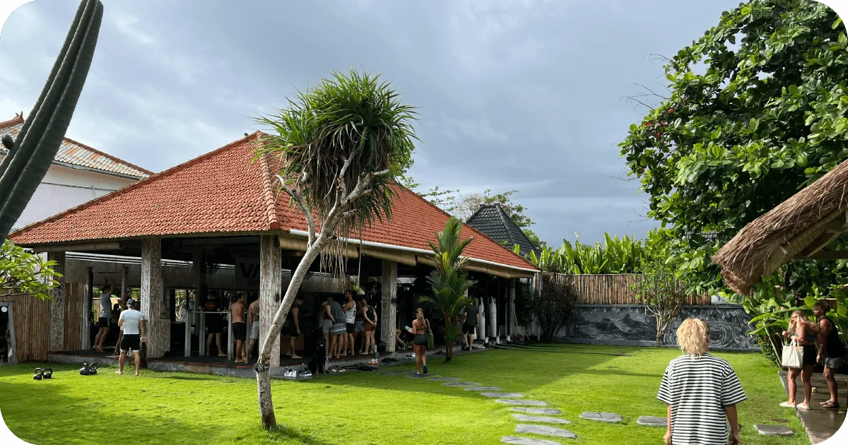 Open-air pavilion gym with red tile roof and lawn
