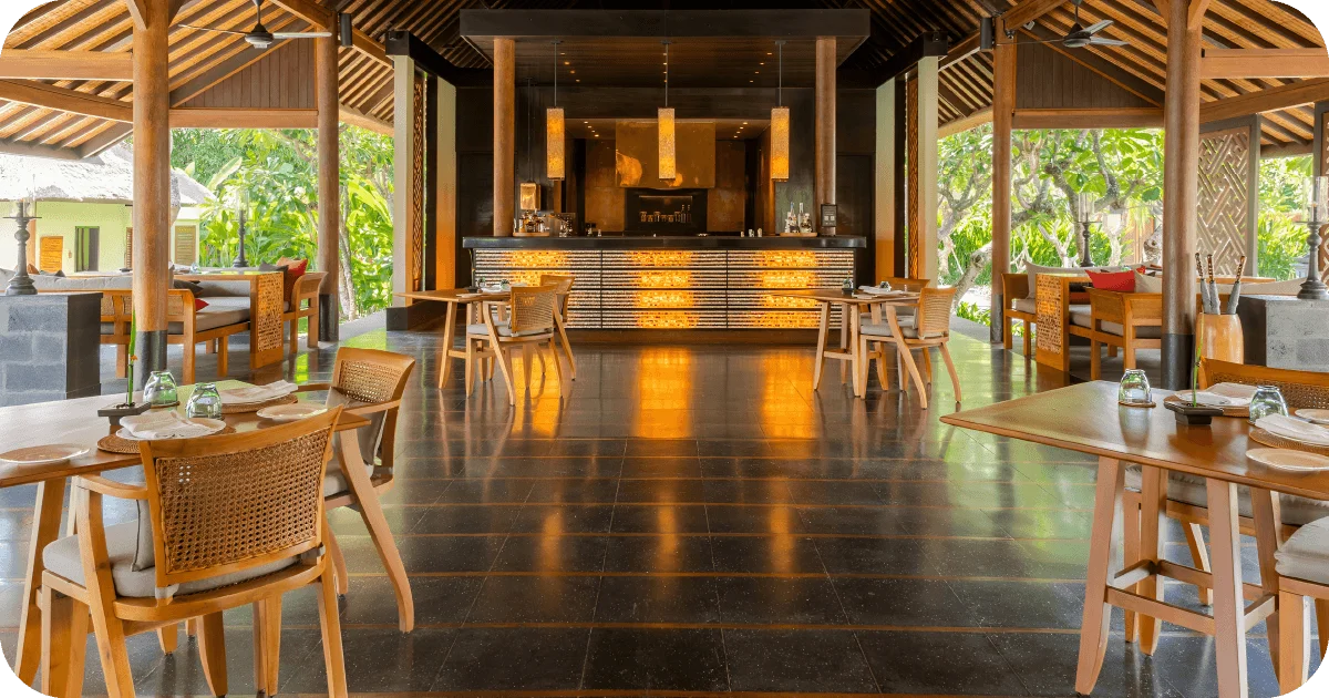 Open-air restaurant bar with glowing counter and wooden table