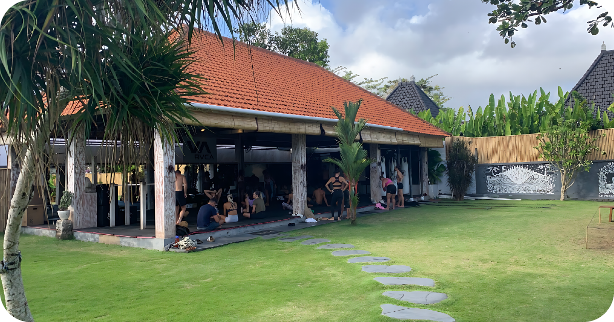 Outdoor pavilion gym with class gathering beside large lawn