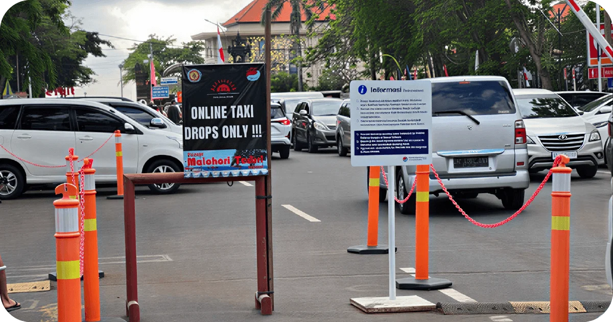 Pickup zone sign reading ONLINE TAKI DROPS ONLY amid traffic